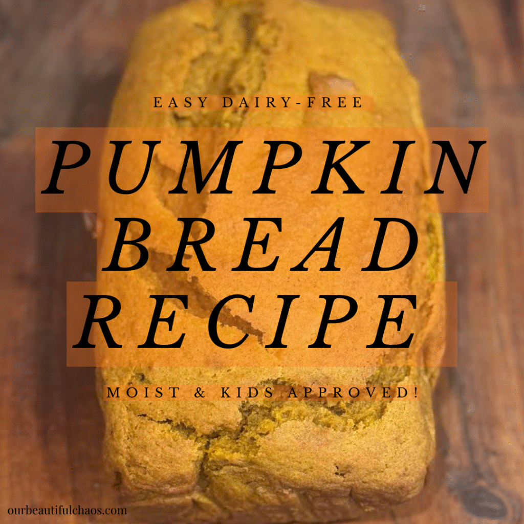Freshly baked loaf of dairy-free pumpkin bread on parchment paper.
